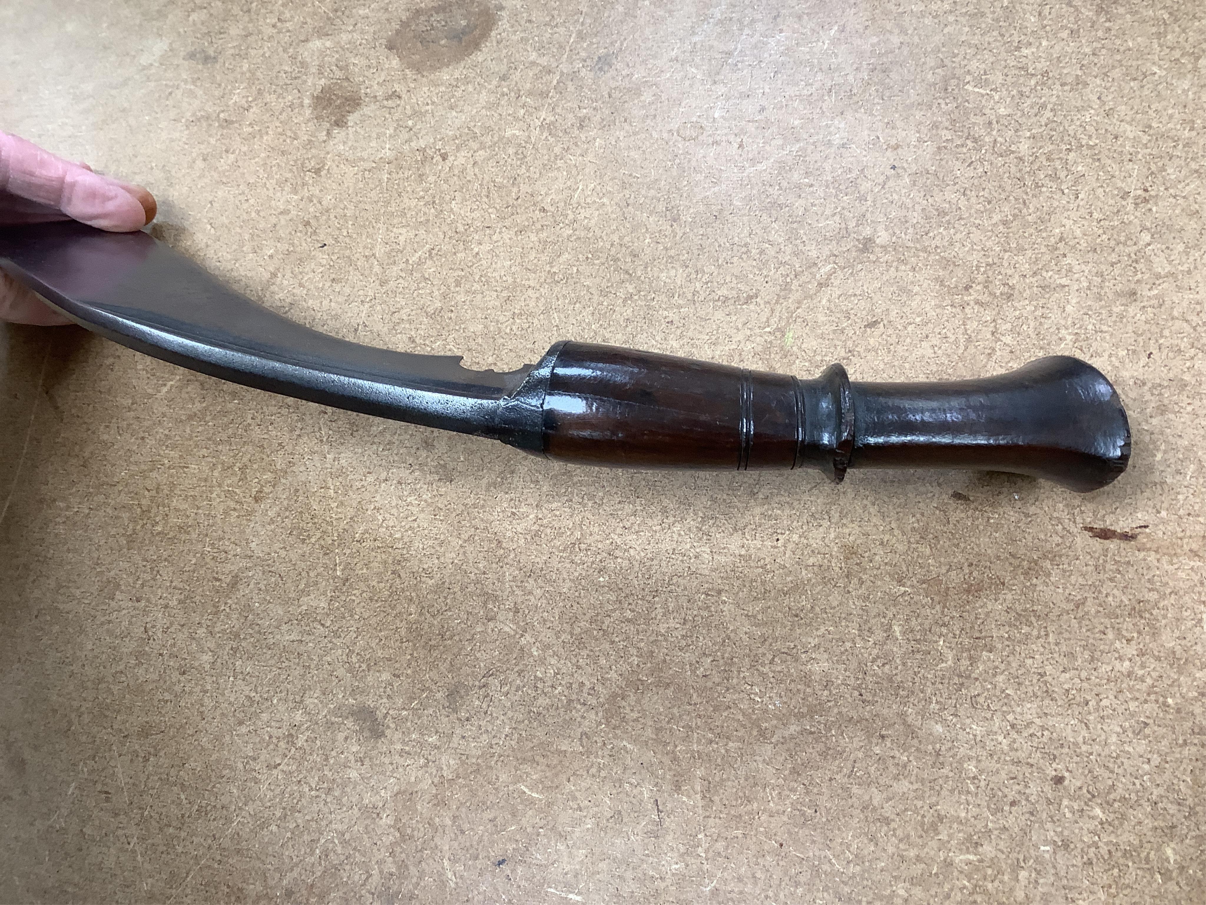 Four bladed weapons; an Indian sword Tulwar, blade 68.5cm. Condition - poor, heavily pitted., A Nepalese Kukri. Condition - fair., A Thai sword Dha, with a lacquered hilt and wooden scabbard, blade 56cm. Condition - fair